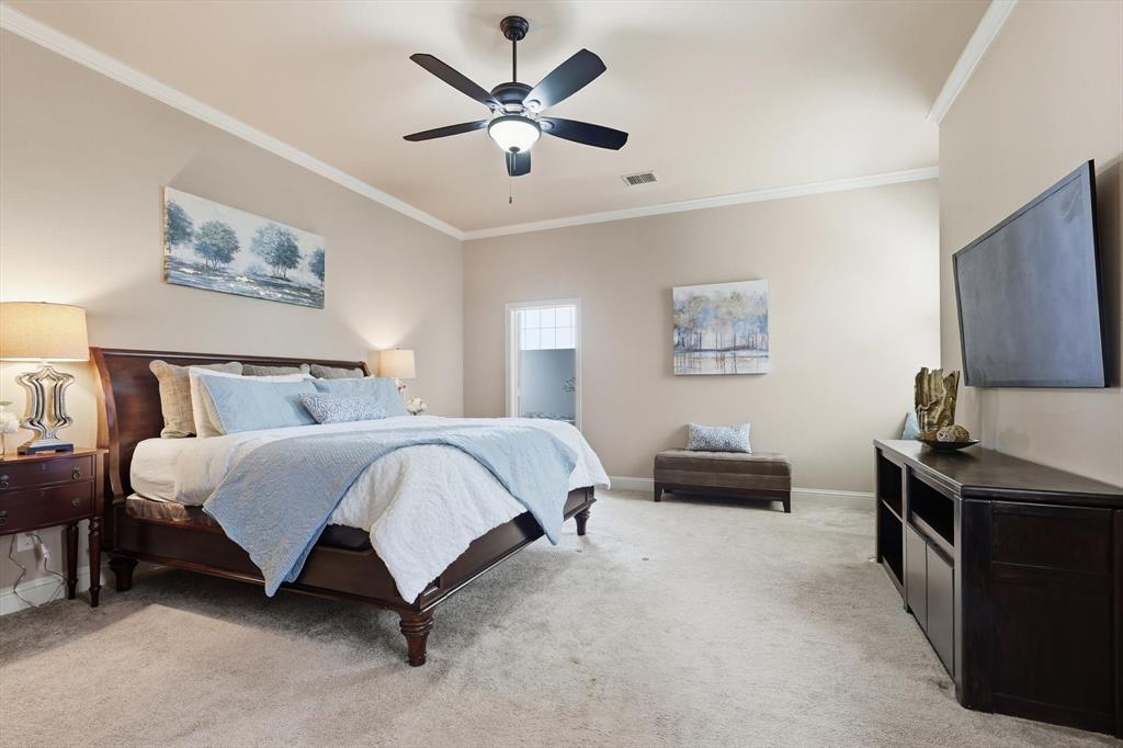 617 Two Creeks Plaza Richardson, TX 75080 - Photo 17 of 40 a spacious bedroom with a bed and a chandelier