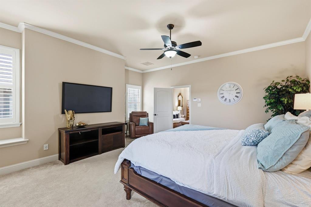 617 Two Creeks Plaza Richardson, TX 75080 - Photo 18 of 40 a bedroom with a bed and a flat screen tv