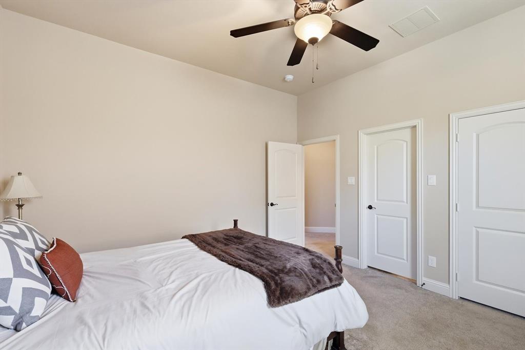 617 Two Creeks Plaza Richardson, TX 75080 - Photo 27 of 40 a bedroom with a bed and a chandelier