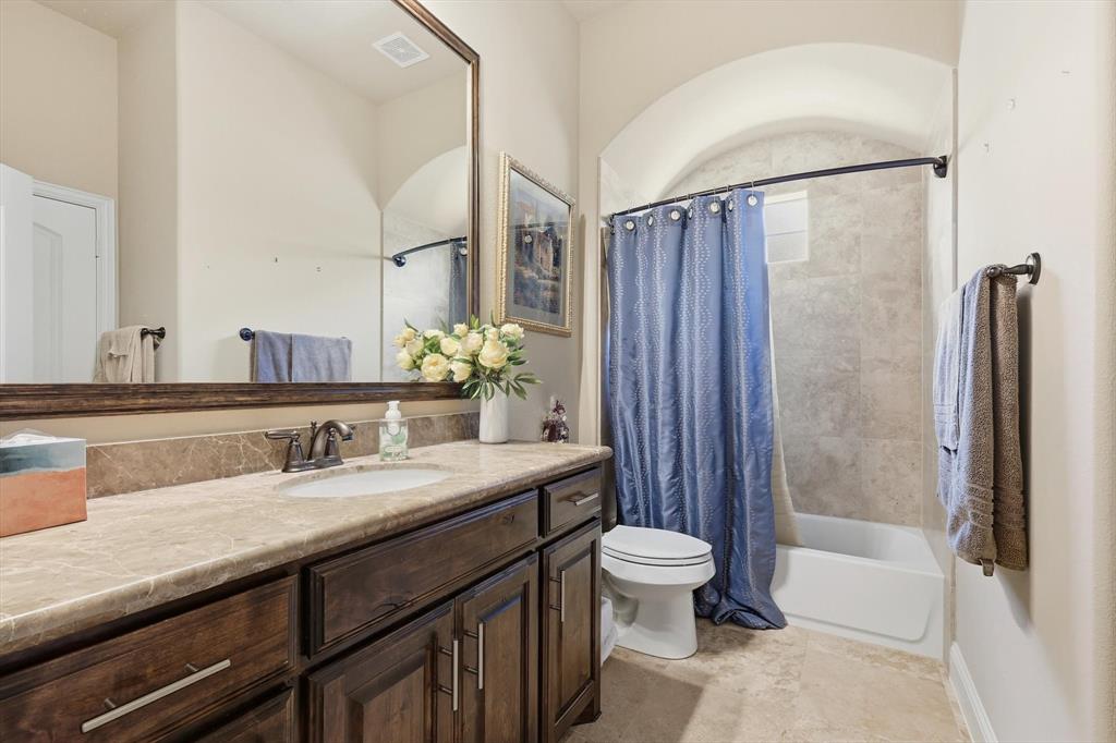 617 Two Creeks Plaza Richardson, TX 75080 - Photo 28 of 40 a bathroom with a granite countertop sink toilet and shower
