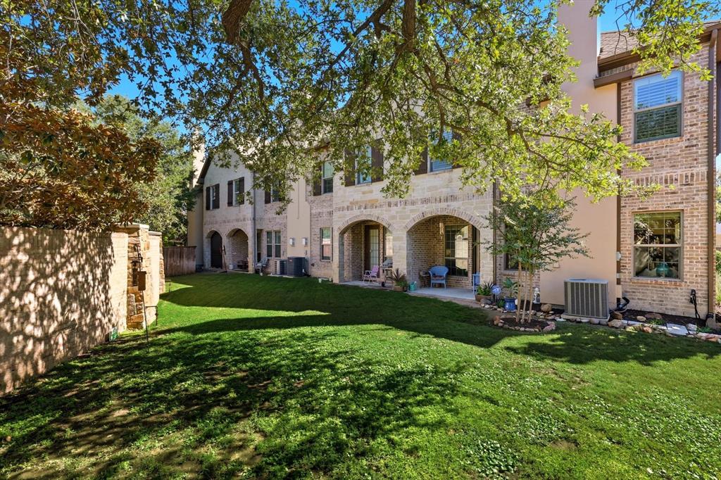 617 Two Creeks Plaza Richardson, TX 75080 - Photo 35 of 40 a view of a white house with a big yard plants and large trees