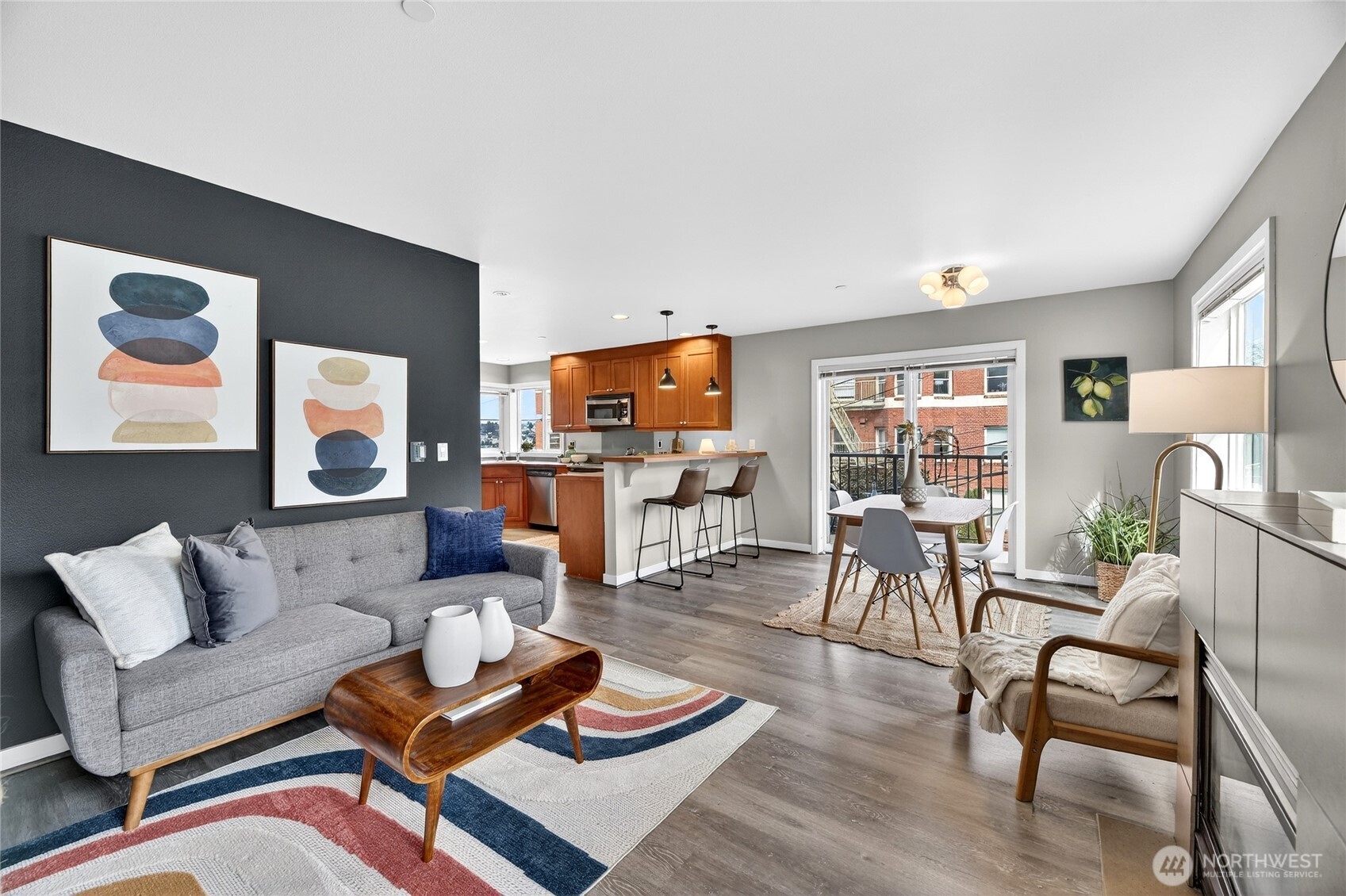 a living room with furniture and a wooden floor