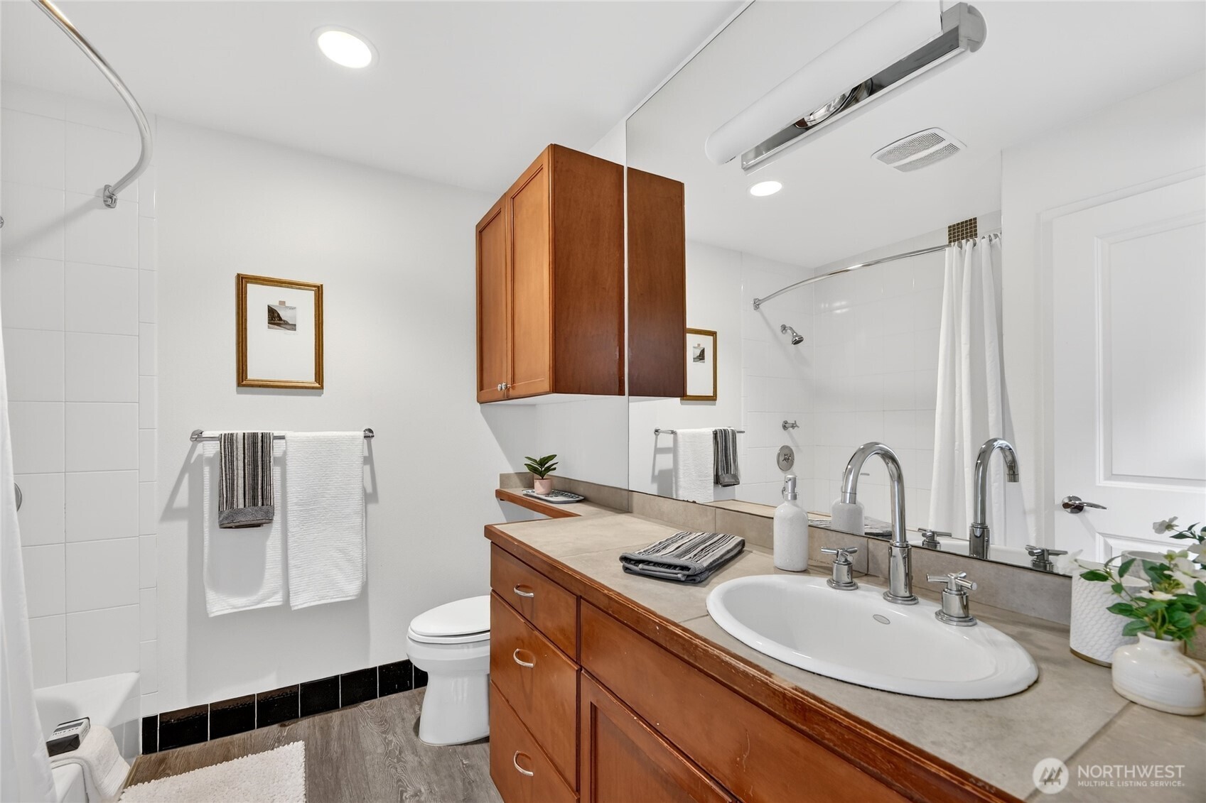 321 East Thomas Street, Unit 303 Seattle, WA 98102 - Photo 14 of 24 a bathroom with a granite countertop sink toilet and mirror