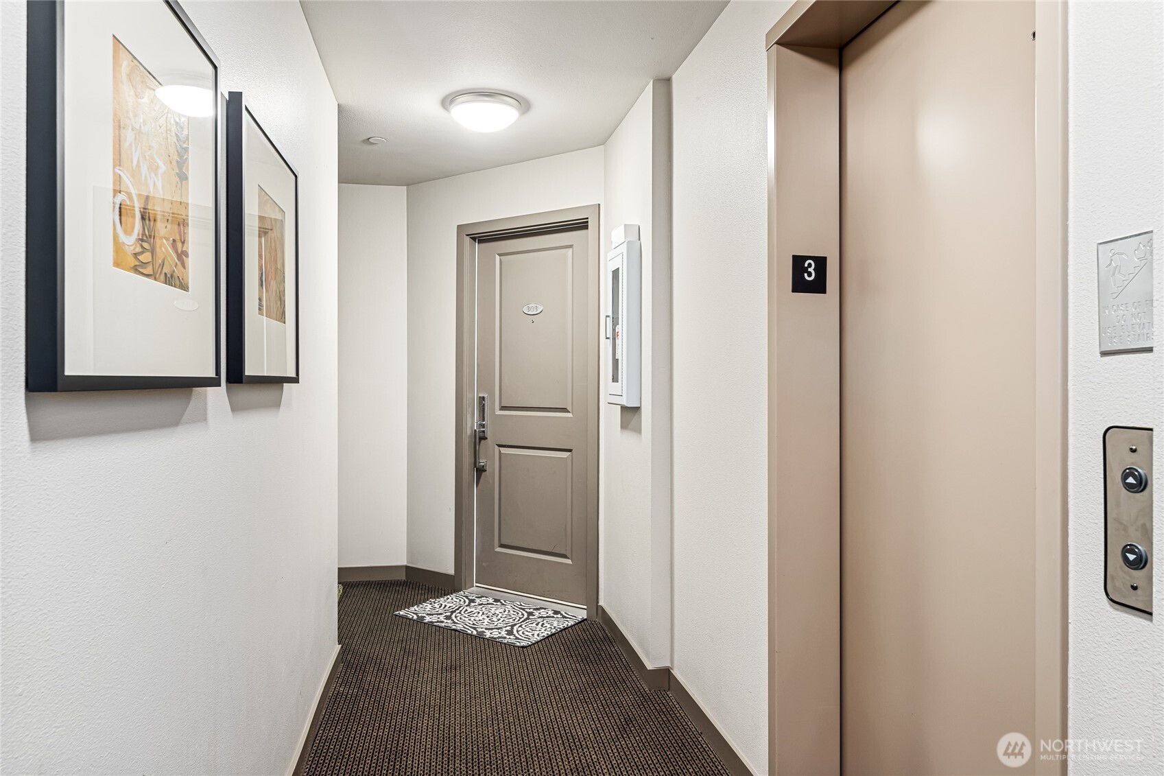 321 East Thomas Street, Unit 303 Seattle, WA 98102 - Photo 23 of 24 a view of a hallway with wooden floor and closet