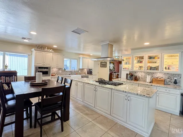 a kitchen with stainless steel appliances granite countertop a stove and a refrigerator