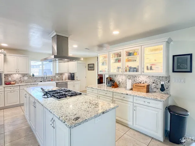 a stove top oven sitting inside of a kitchen