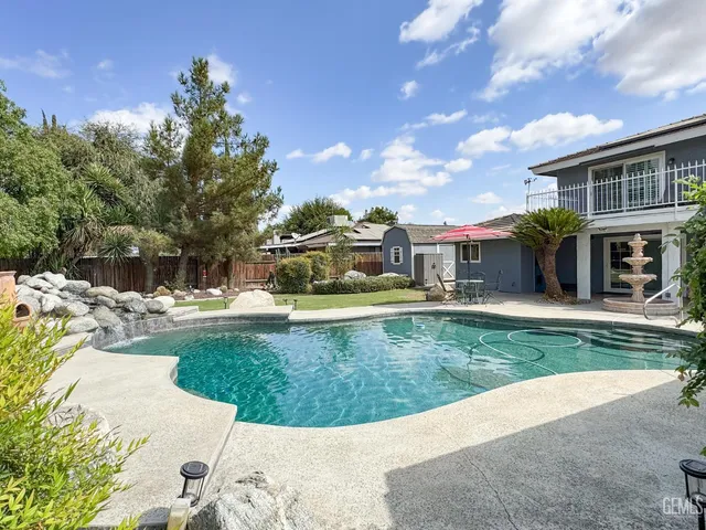 a balcony with wooden floor table and chairs