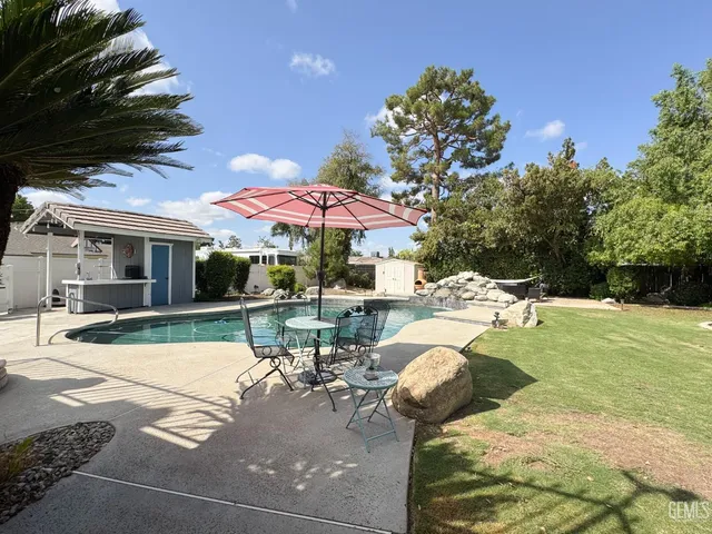 a view of backyard of house with seating space