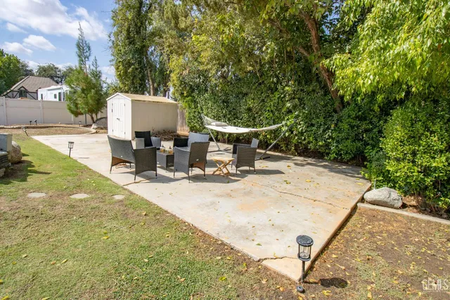 a backyard of a house with table and chairs