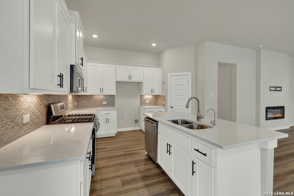 1433 Escarpment Road New Braunfels, TX 78132 - Photo 13 of 37 a kitchen with stainless steel appliances granite countertop a sink stove and refrigerator