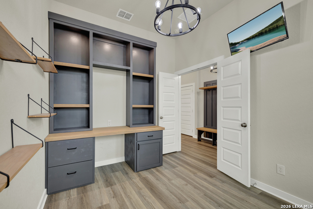 1433 Escarpment Road New Braunfels, TX 78132 - Photo 16 of 37 a kitchen with cabinets and wooden floor