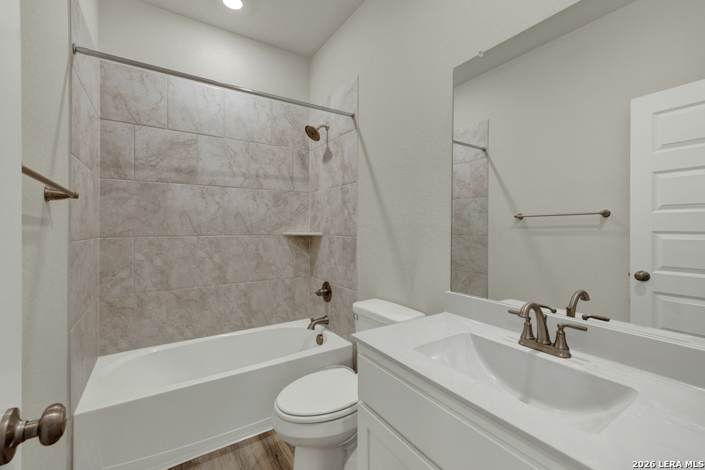 1433 Escarpment Road New Braunfels, TX 78132 - Photo 23 of 37 a bathroom with a sink a toilet and a bathtub