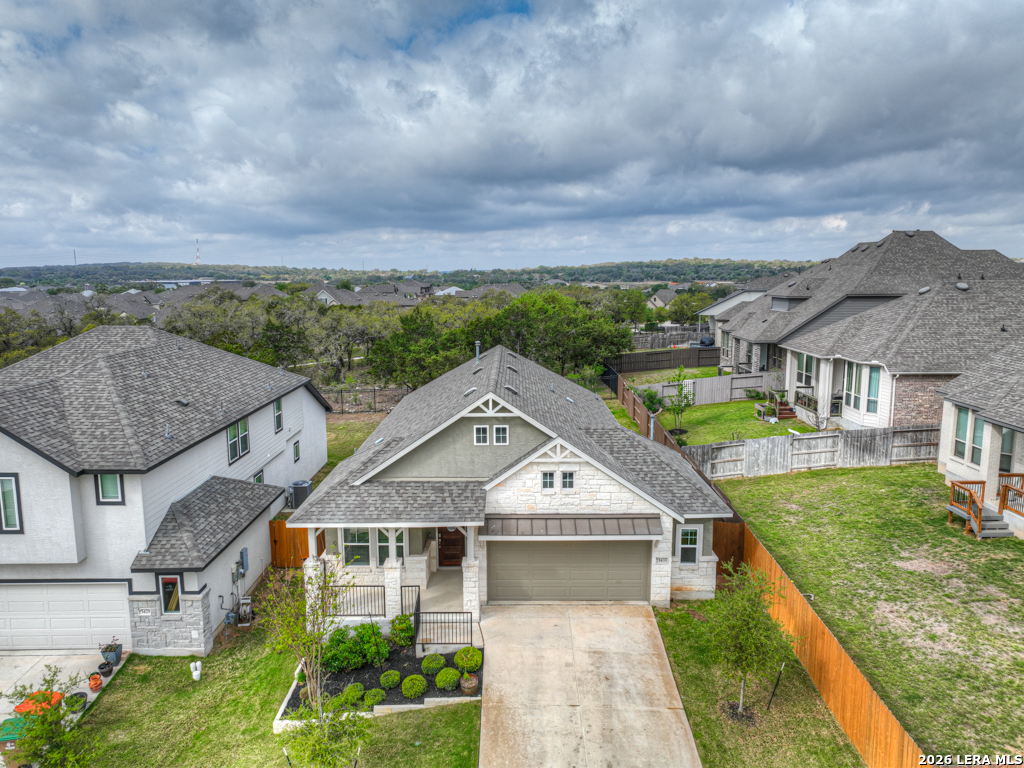 1433 Escarpment Road New Braunfels, TX 78132 - Photo 35 of 37 an aerial view of a house with a big yard and large tree