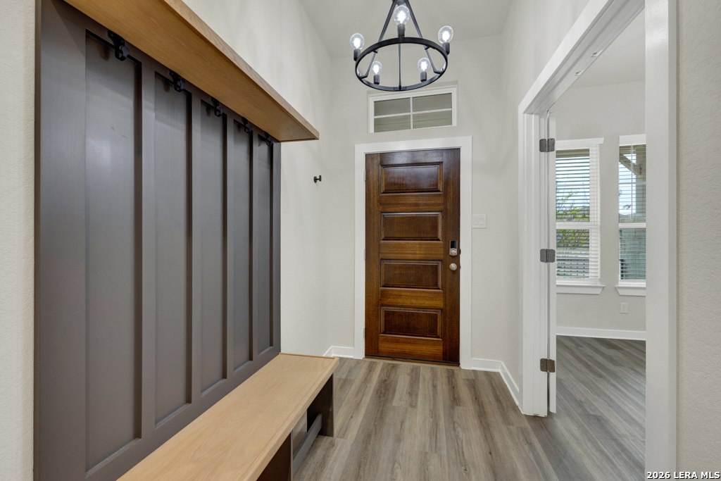 1433 Escarpment Road New Braunfels, TX 78132 - Photo 4 of 37 a view of a hallway with wooden floor and staircase
