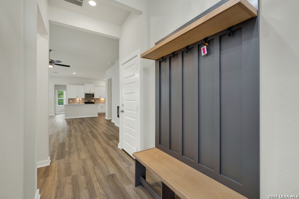 1433 Escarpment Road New Braunfels, TX 78132 - Photo 5 of 37 a view of hallway with wooden floor