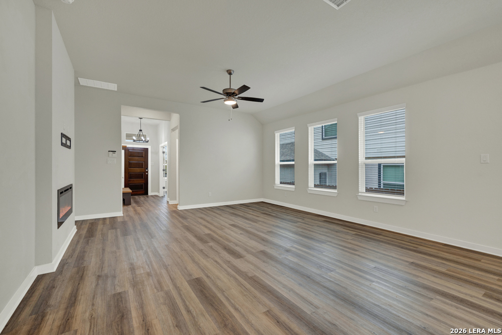 1433 Escarpment Road New Braunfels, TX 78132 - Photo 8 of 37 a view of an empty room with a window and wooden floor