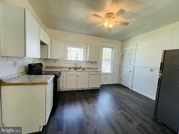a kitchen with a sink a refrigerator a stove and cabinets