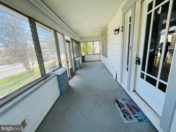 a view of hallway with furniture and a large window