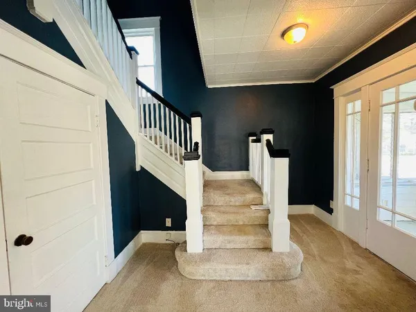 a view of entryway and hall with wooden floor