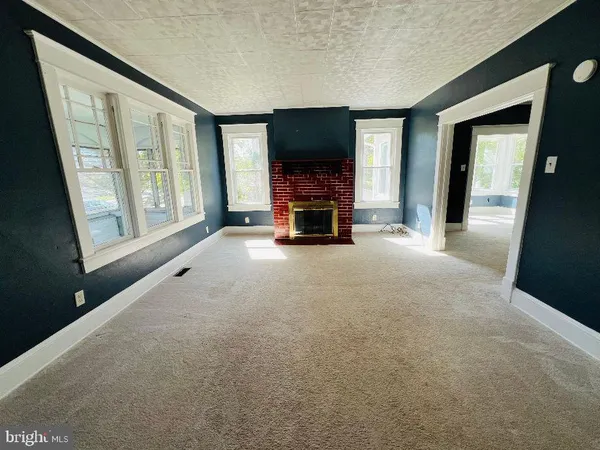 a view of a livingroom with furniture a flat screen tv and floor to ceiling window