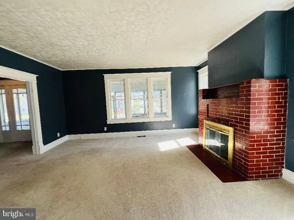 a view of empty room with a fireplace