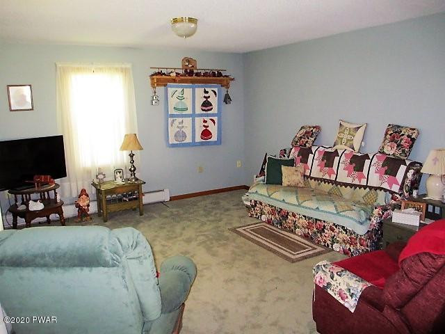 996 Cortez Road Lake Ariel, PA 18436 - Photo 19 of 55 a living room with furniture and a flat screen tv