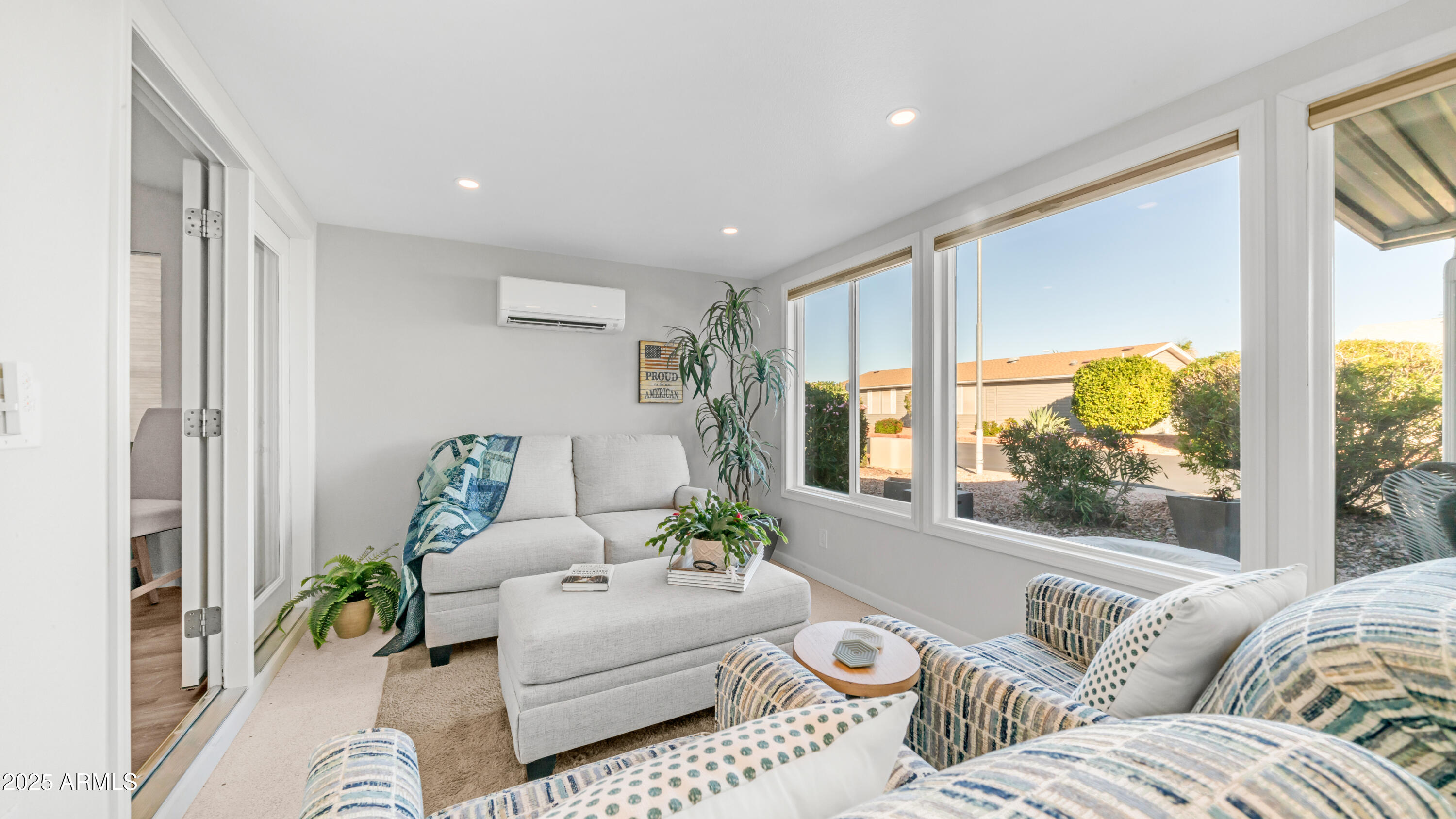 2550 South Ellsworth Road, Unit 751 Mesa, AZ 85209 - Photo 12 of 27 a living room with furniture and a large window