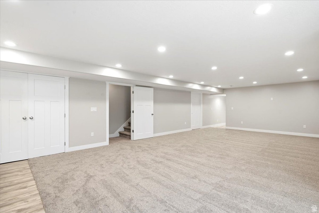 2973 West Red Sand Rd Haven Ogden, UT 84401 - Photo 19 of 30 Spacious room featuring neutral carpeting, light gray walls, white trim, recessed lighting, and white paneled doors