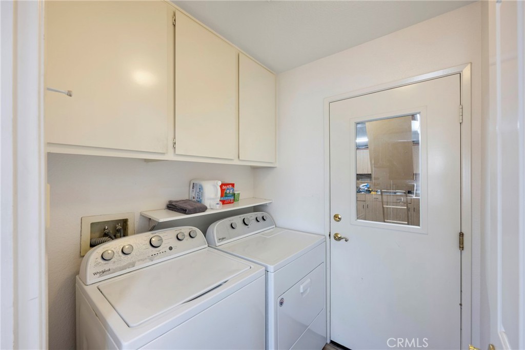 40370 Vía Francisco Murrieta, CA 92562 - Photo 25 of 52 a view of washer and dryer with kitchen in the background
