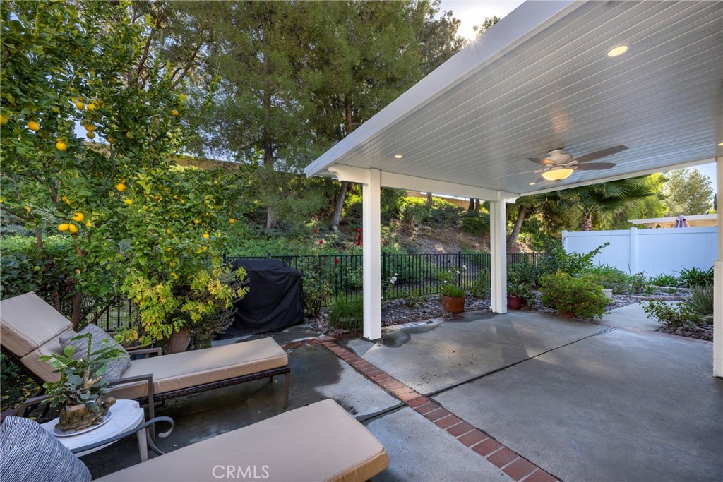 40370 Vía Francisco Murrieta, CA 92562 - Photo 27 of 52 a view of a patio with couches table and chairs potted plants and large tree