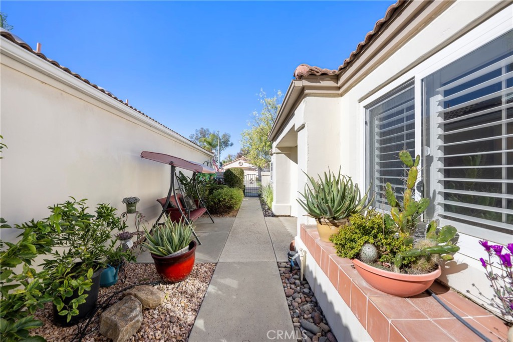 40370 Vía Francisco Murrieta, CA 92562 - Photo 51 of 52 a house with a flower garden and potted plants