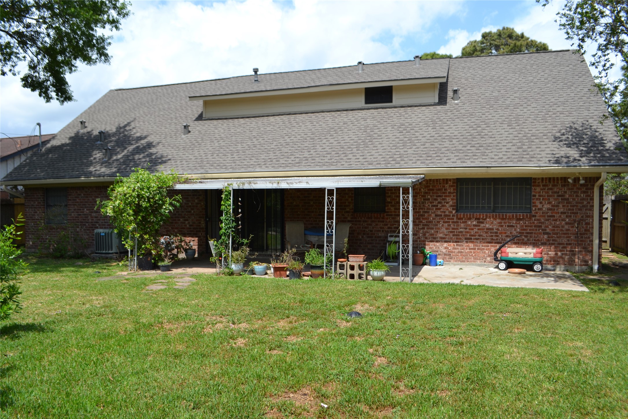 322 Ravenhead Drive Houston, TX 77034 - Photo 15 of 16 a front view of a house with a garden and porch