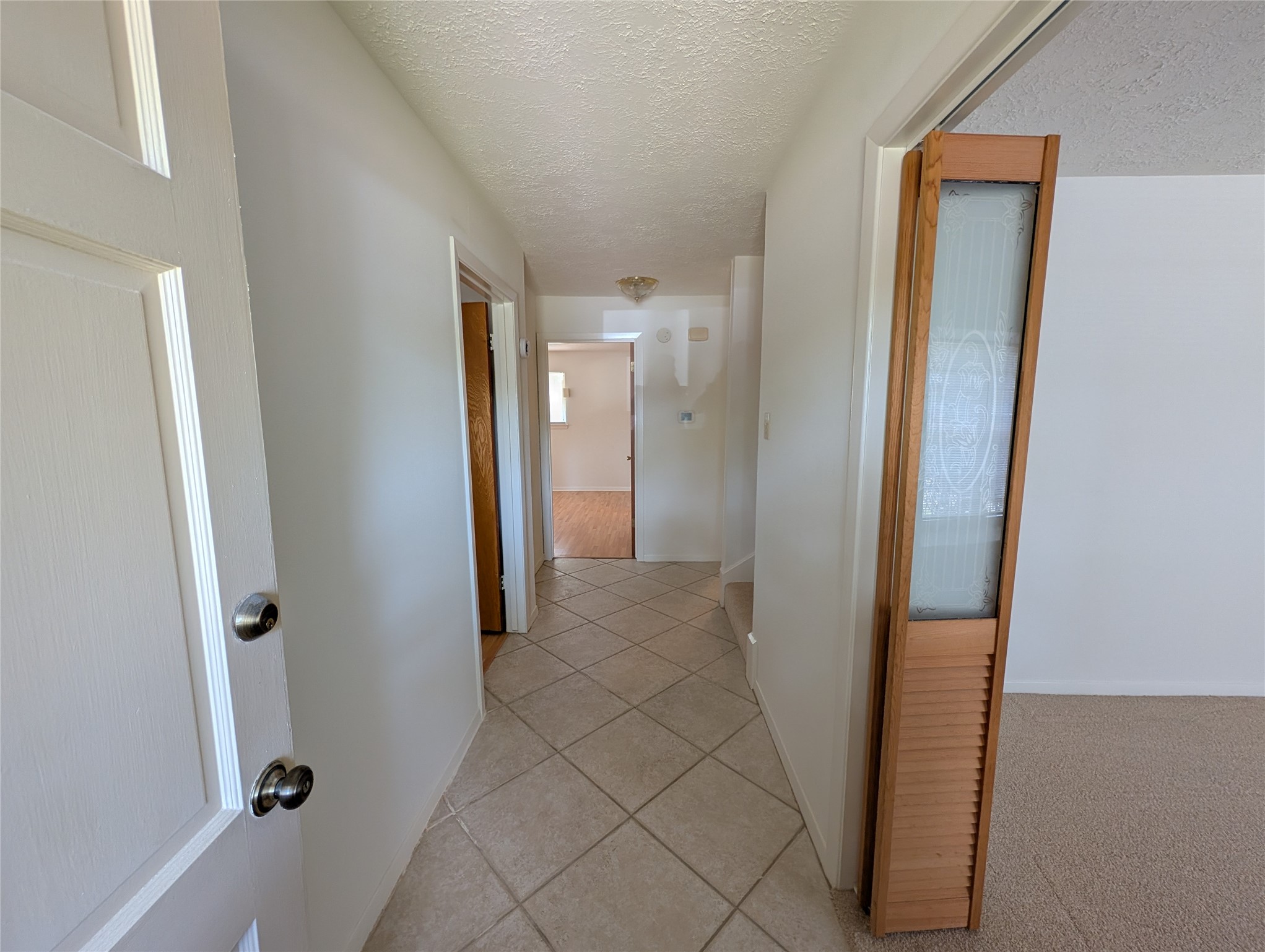 322 Ravenhead Drive Houston, TX 77034 - Photo 2 of 16 a view of a hallway with wooden floor and closet