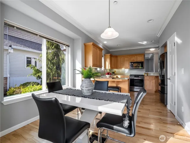 a dining room with furniture a window and wooden floor