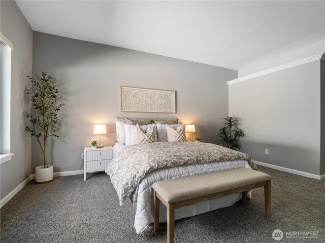 a bedroom with a bed and a potted plant
