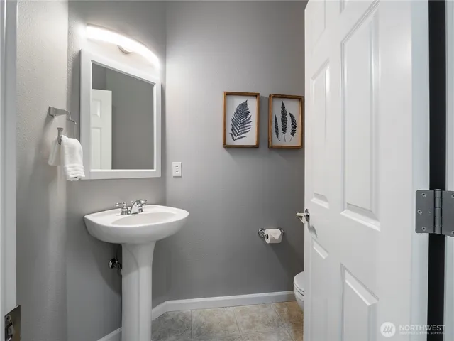a bathroom with a sink mirror and toilet