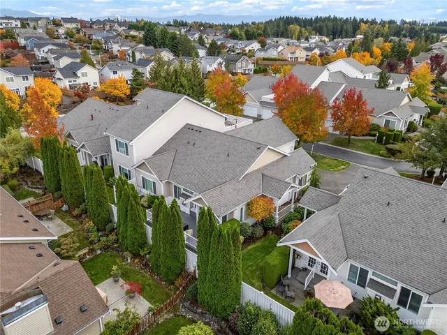an aerial view of residential houses with outdoor space