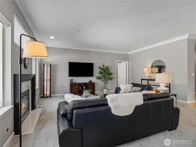 a living room with fireplace furniture and a flat screen tv