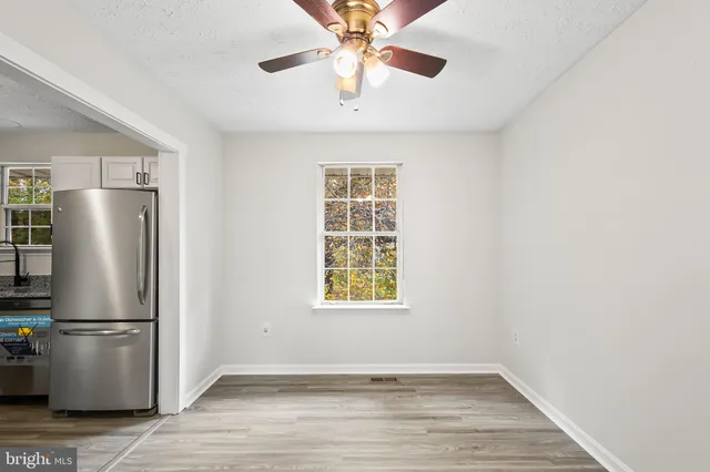 a view of a kitchen with a ceiling fan and a window