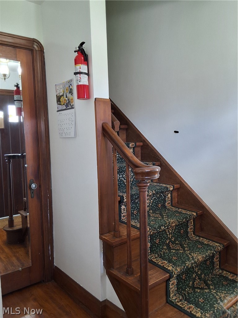236 Bowland Road Mansfield, OH 44907 - Photo 12 of 34 Hardwood staircase featuring a patterned runner and a matching wood balustrade