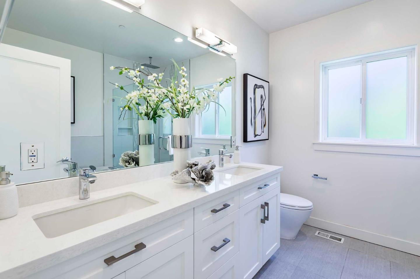 285 West Charleston Road Palo Alto, CA 94306 - Photo 21 of 25 a bathroom with a double vanity sink and a mirror