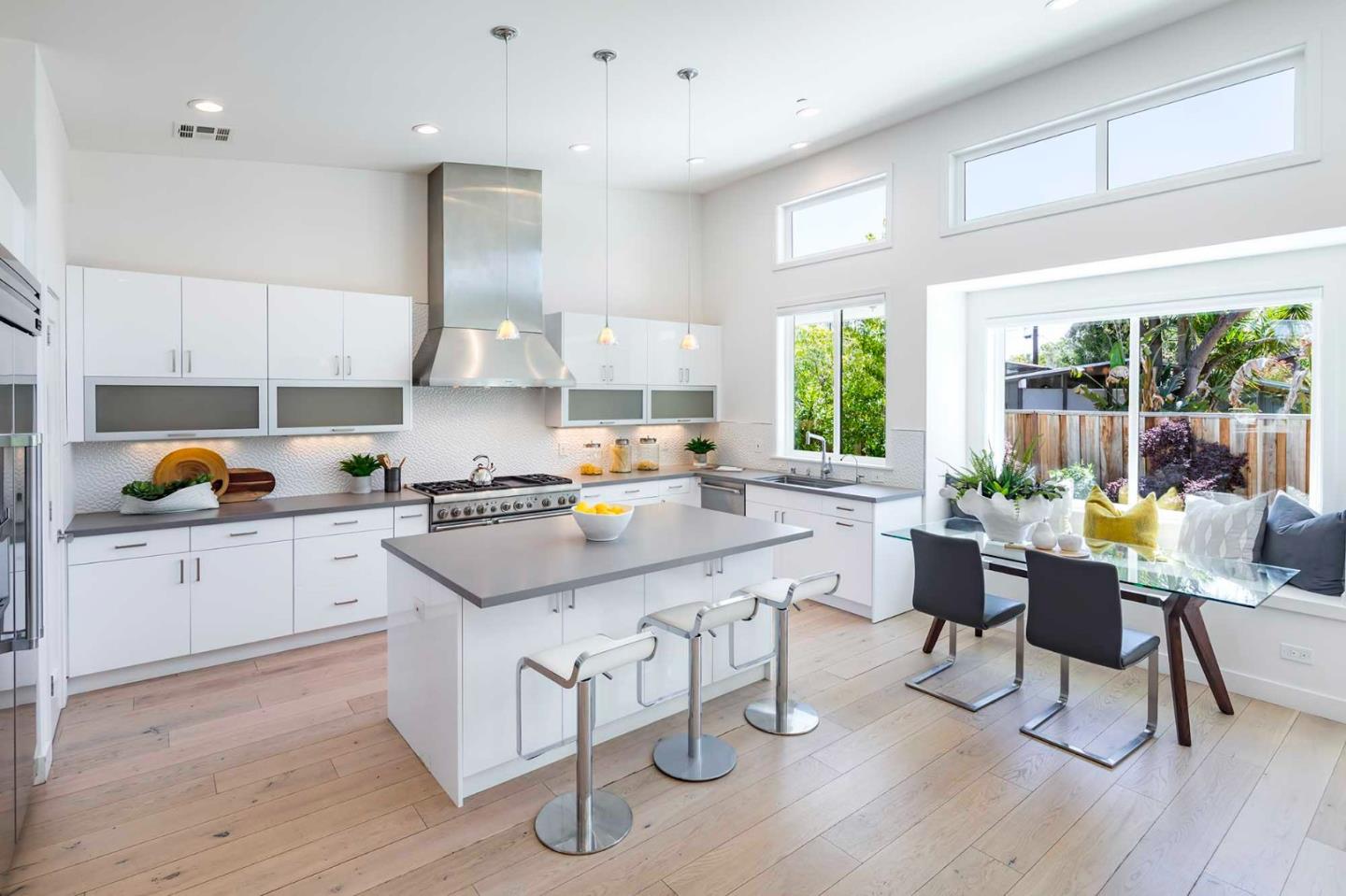 285 West Charleston Road Palo Alto, CA 94306 - Photo 7 of 25 a kitchen with stainless steel appliances granite countertop a stove a sink dishwasher a dining table and chairs with wooden floor