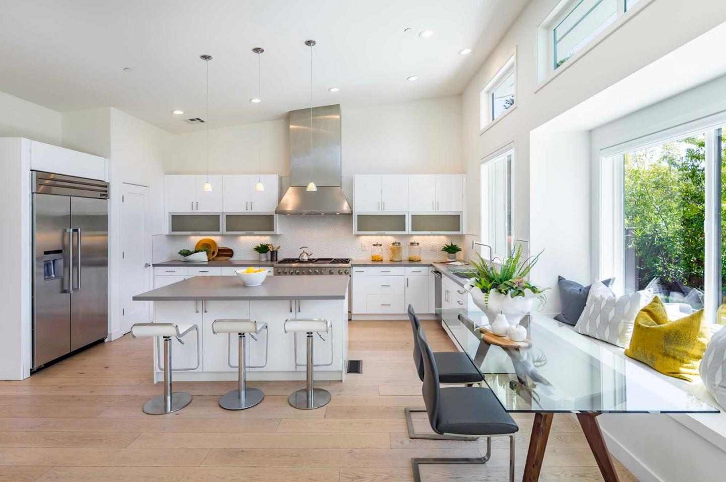 285 West Charleston Road Palo Alto, CA 94306 - Photo 8 of 25 a kitchen with stainless steel appliances kitchen island granite countertop a table chairs sink and cabinets
