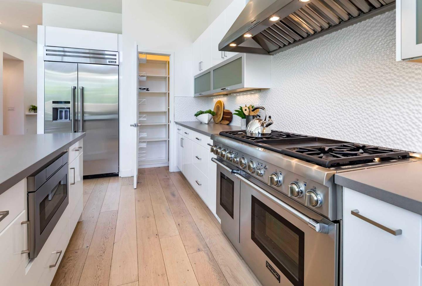 285 West Charleston Road Palo Alto, CA 94306 - Photo 9 of 25 a kitchen with stainless steel appliances granite countertop a stove and a refrigerator