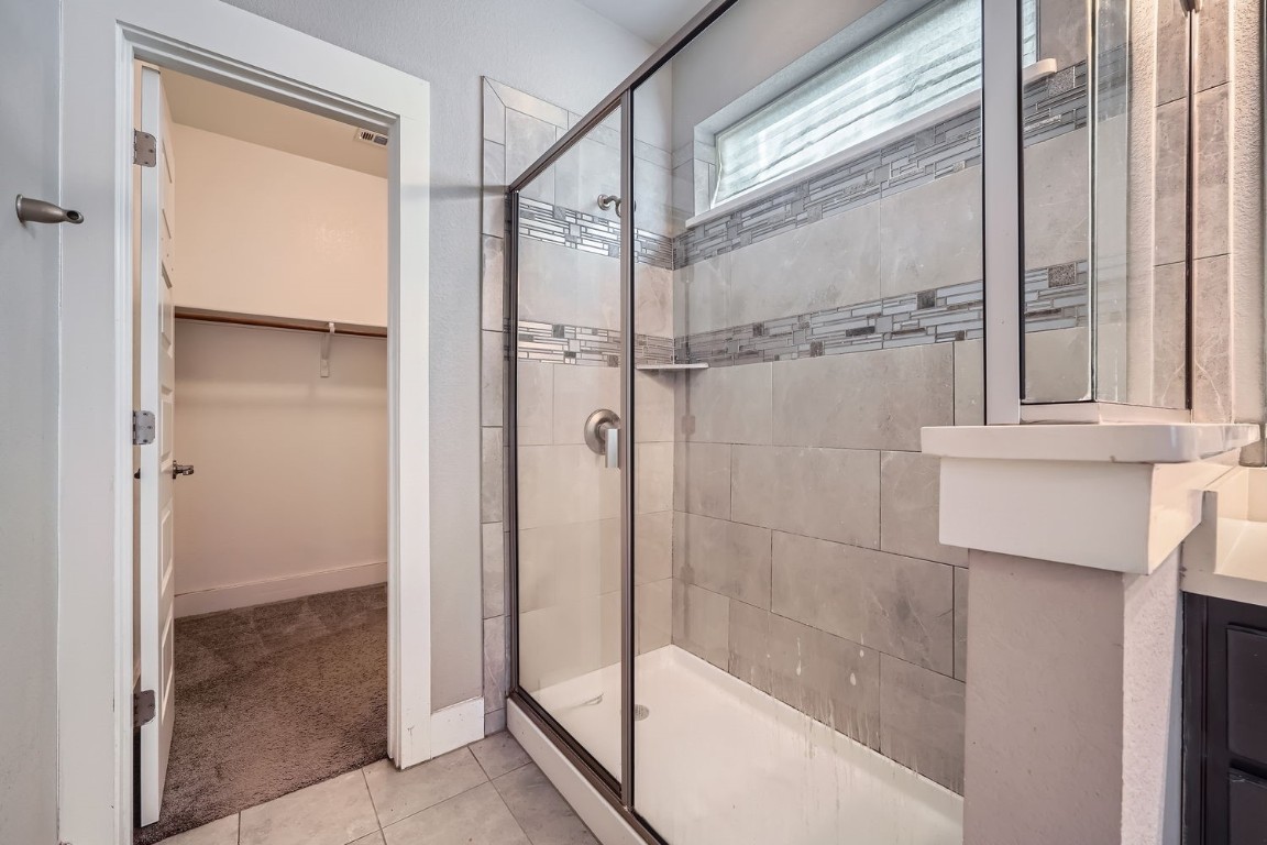 14709 Stillman Bend, Unit 52 Austin, TX 78717 - Photo 17 of 28 a bathroom with a glass shower door