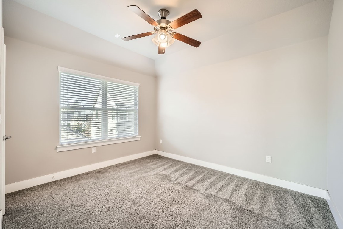 14709 Stillman Bend, Unit 52 Austin, TX 78717 - Photo 24 of 28 an empty room with a window and a fan