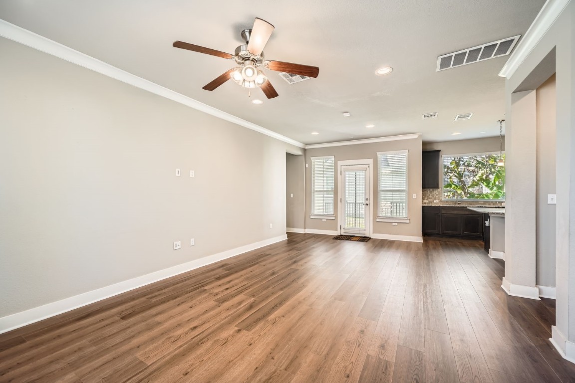 14709 Stillman Bend, Unit 52 Austin, TX 78717 - Photo 25 of 28 a view of an empty room with a window and wooden floor
