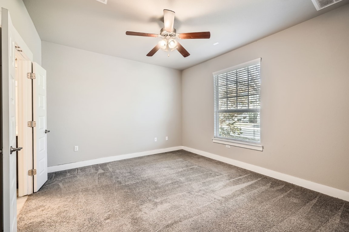 14709 Stillman Bend, Unit 52 Austin, TX 78717 - Photo 26 of 28 an empty room with windows and fan