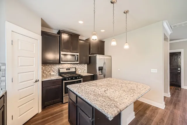 a kitchen with a sink refrigerator and microwave
