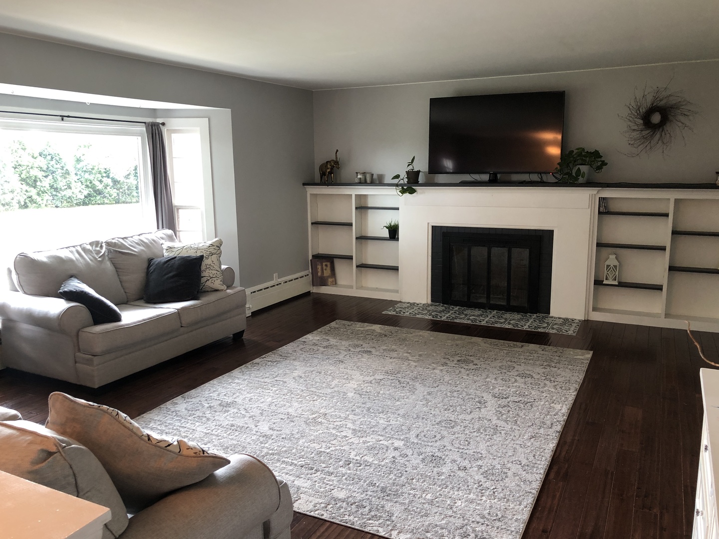 12907 Barber Greene Road Sycamore, IL 60178 - Photo 17 of 42 a living room with furniture a flat screen tv and a fireplace